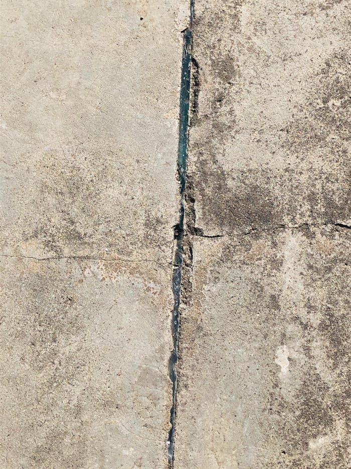 Detailed view of a cracked concrete surface highlighting structural damage.